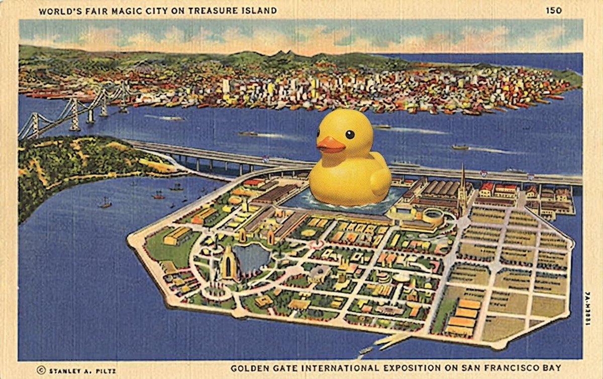 A vintage postcard depicts a fantastical city built on Treasure Island, featuring a giant yellow rubber duck floating in the center, surrounded by colorful buildings and roads, with the Golden Gate Bridge and San Francisco Bay in the background.