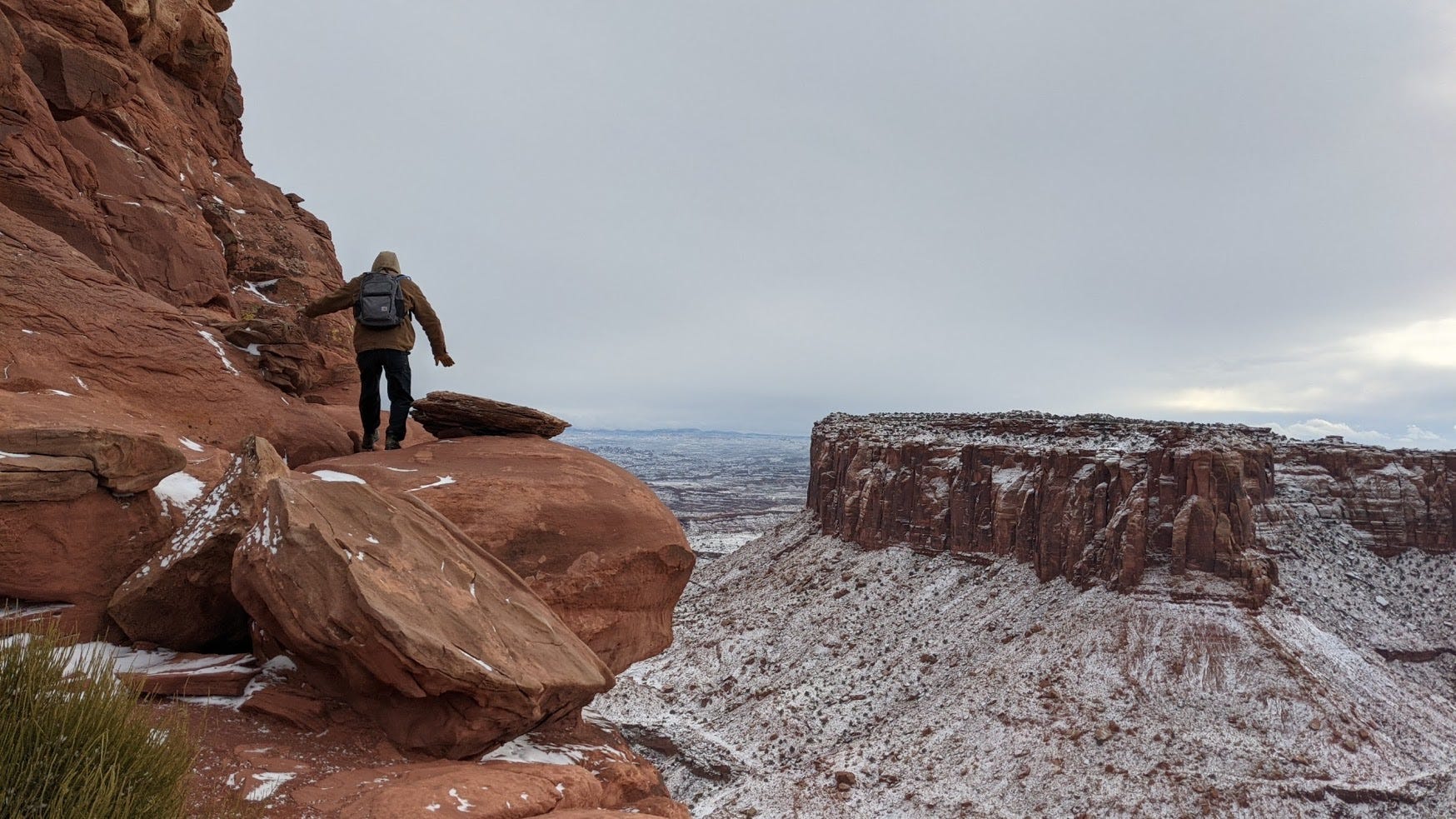 a picture of me on the edge of a wide canyon in the snow